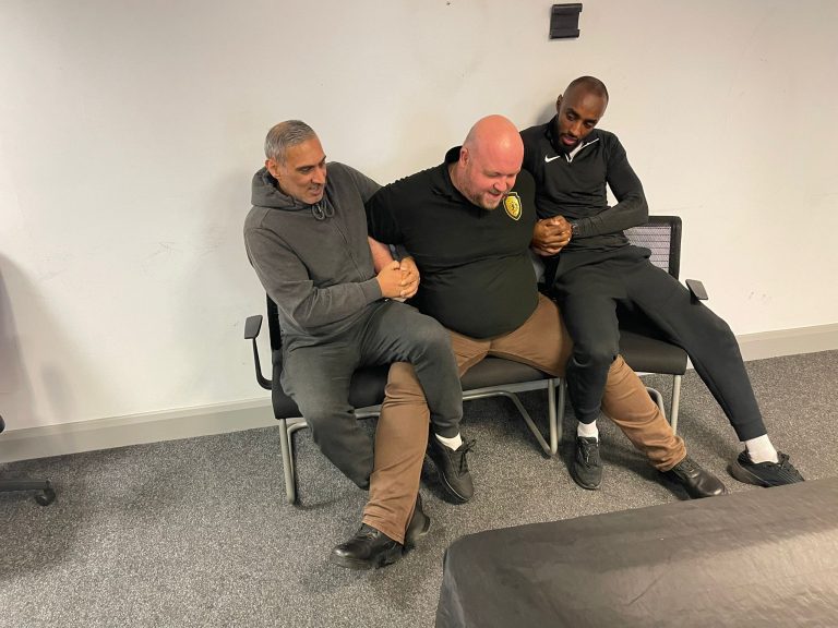 Instructor being restrained